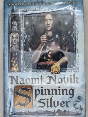 New York Times best seller “One of the year’s strongest fantasy novels” (NPR), an imaginative retelling of the Rumpelstiltskin fairy tale from the best-selling author of Uprooted. Nebula and Hugo Award Finalist Named one of Paste's Best Fantasy Books of the Decade Named one of the top 10 books of the year by The New York Public Library and one of the best books of the year by: The New York Times Book Review; NPR; Time; Tor.com; PopSugar; Vox; Vulture; Paste; Bustle; Library Journal With the Nebula Award-winning Uprooted, Naomi Novik opened a brilliant new chapter in an already acclaimed career, delving into the magic of fairy tales to craft a love story that was both timeless and utterly of the now. Spinning Silver draws listeners deeper into this glittering realm of fantasy, where the boundary between wonder and terror is thinner than a breath, and safety can be stolen as quickly as a kiss. Miryem is the daughter and granddaughter of moneylenders, but her father’s inability to collect his debts has left his family on the edge of poverty - until Miryem takes matters into her own hands. Hardening her heart, the young woman sets out to claim what is owed and soon gains a reputation for being able to turn silver into gold. When an ill-advised boast draws the attention of the king of the Staryk - grim fey creatures who seem more ice than flesh - Miryem’s fate, and that of two kingdoms, will be forever altered. She will face an impossible challenge and, along with two unlikely allies, uncover a secret that threatens to consume the lands of humans and Staryk alike.